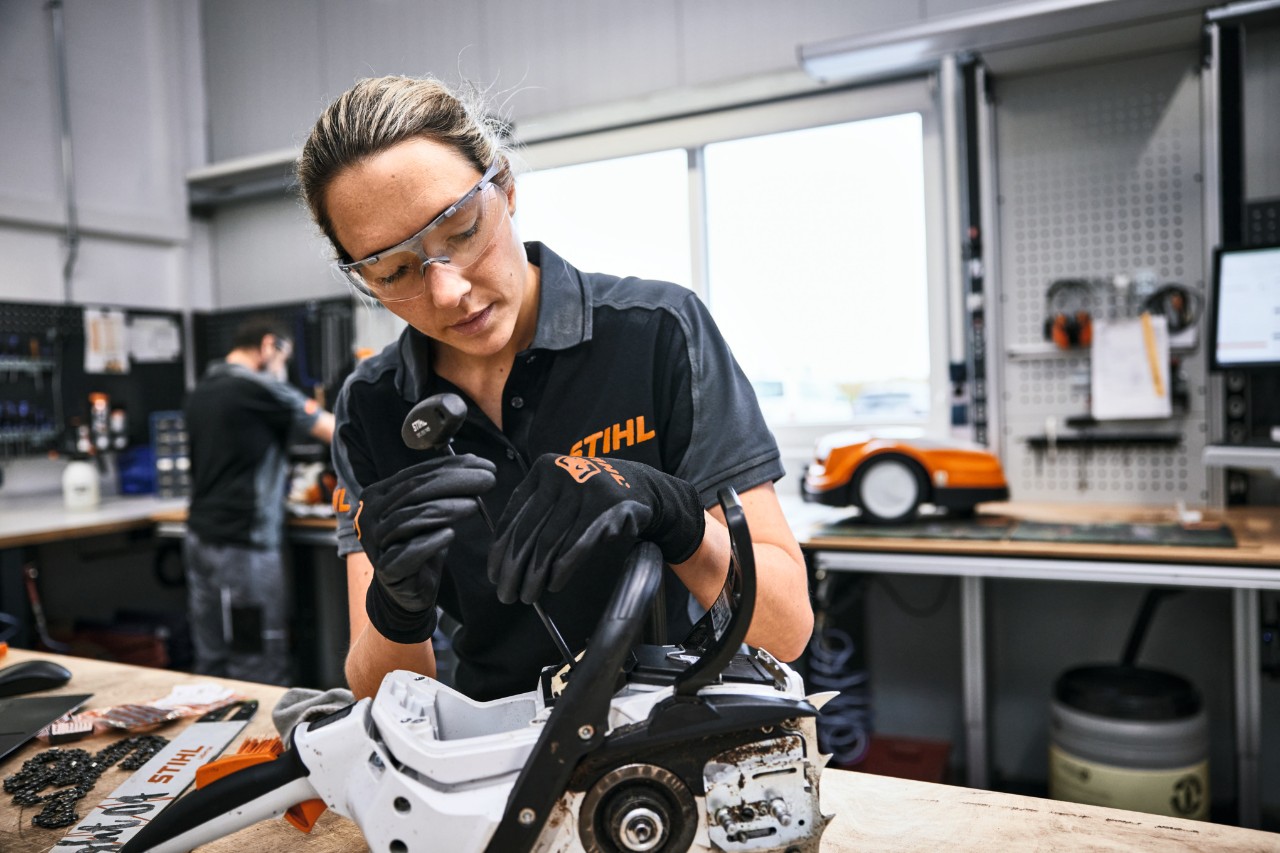 STIHL employee or specialist retailer employee repairs a chainsaw