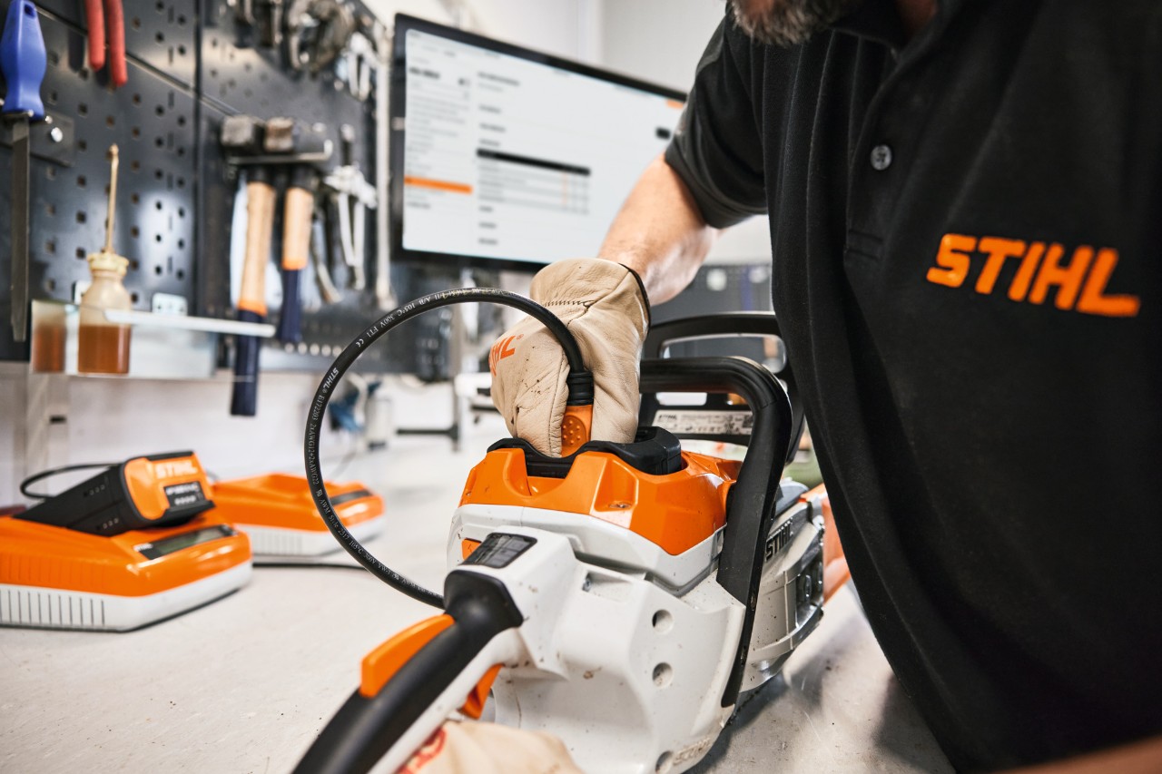 STIHL employee or specialist dealer repairs a chainsaw